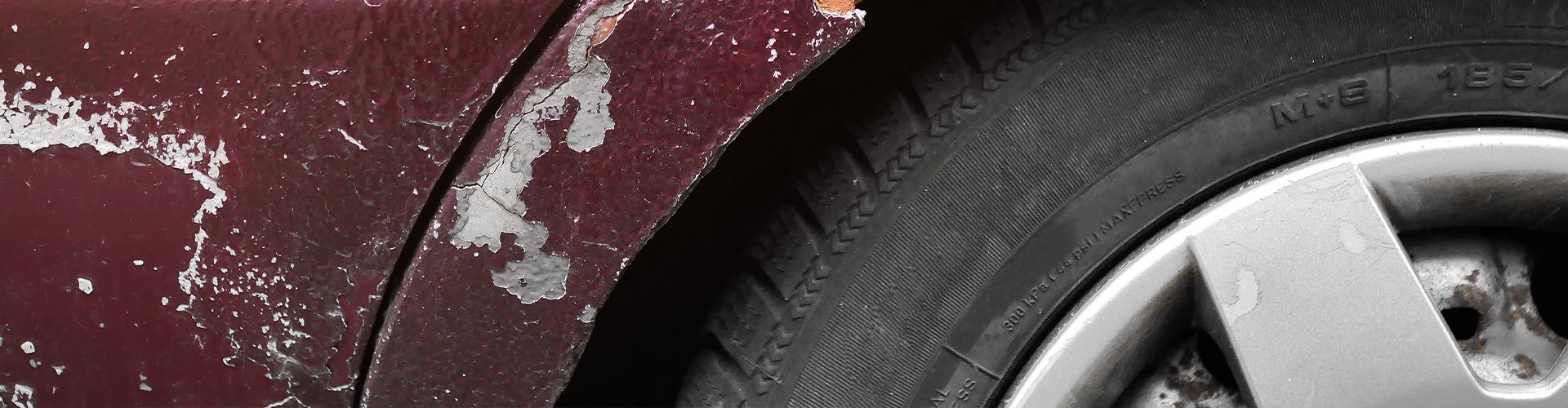 Closeup of the tire and rims of a car.