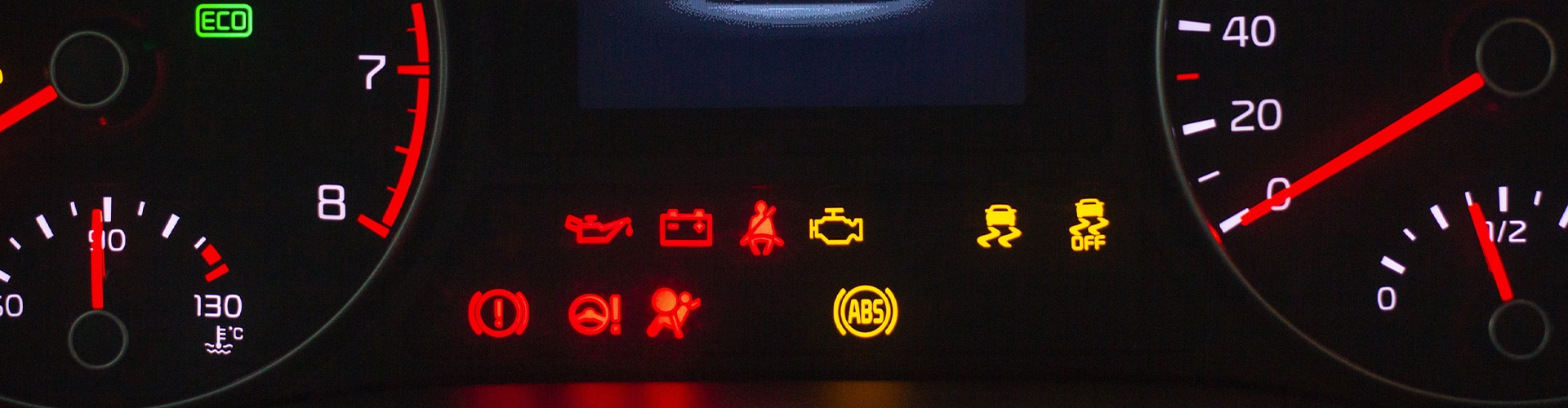 Dashboard of a car showing multiple warning lights, including a check engine and low oil light.