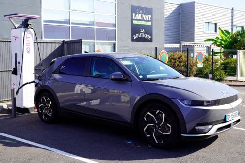 Grey Hyundai Ionic 5 EV parked at a charging station.