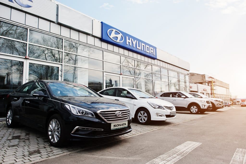 New Hyundai Accent, Sonate, Tucson, and Creta at car dealership.